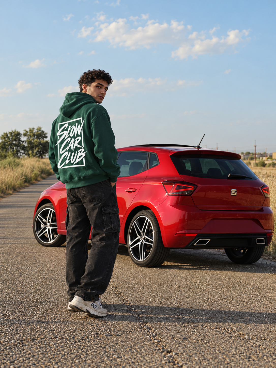 Green Slow Car Club oversized hoodie lifestyle photo with red car